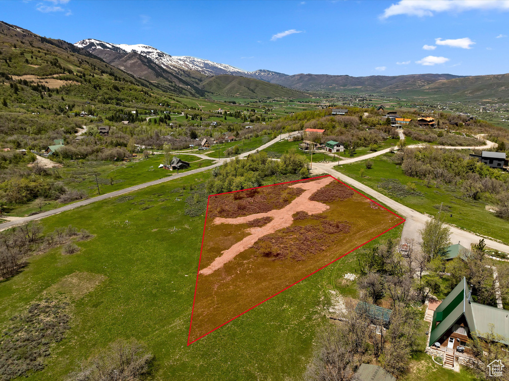 Aerial overview of property's location with property parcel outlined and a mountain backdrop