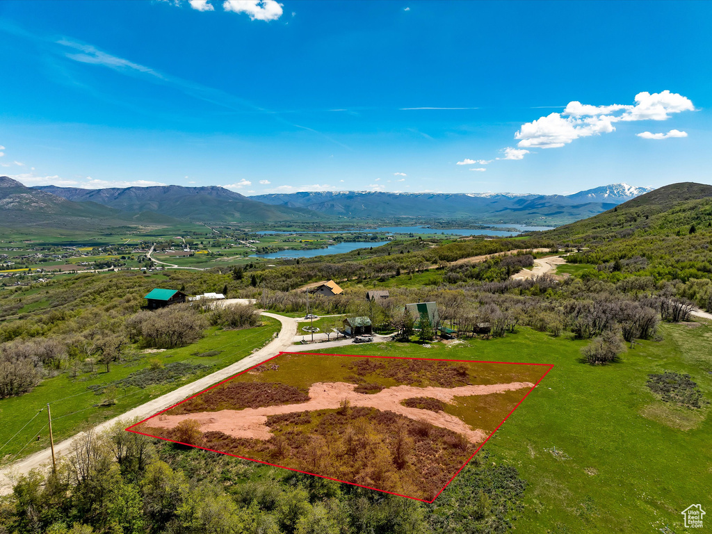 Aerial view of property's location featuring property parcel outlined and a water and mountain view
