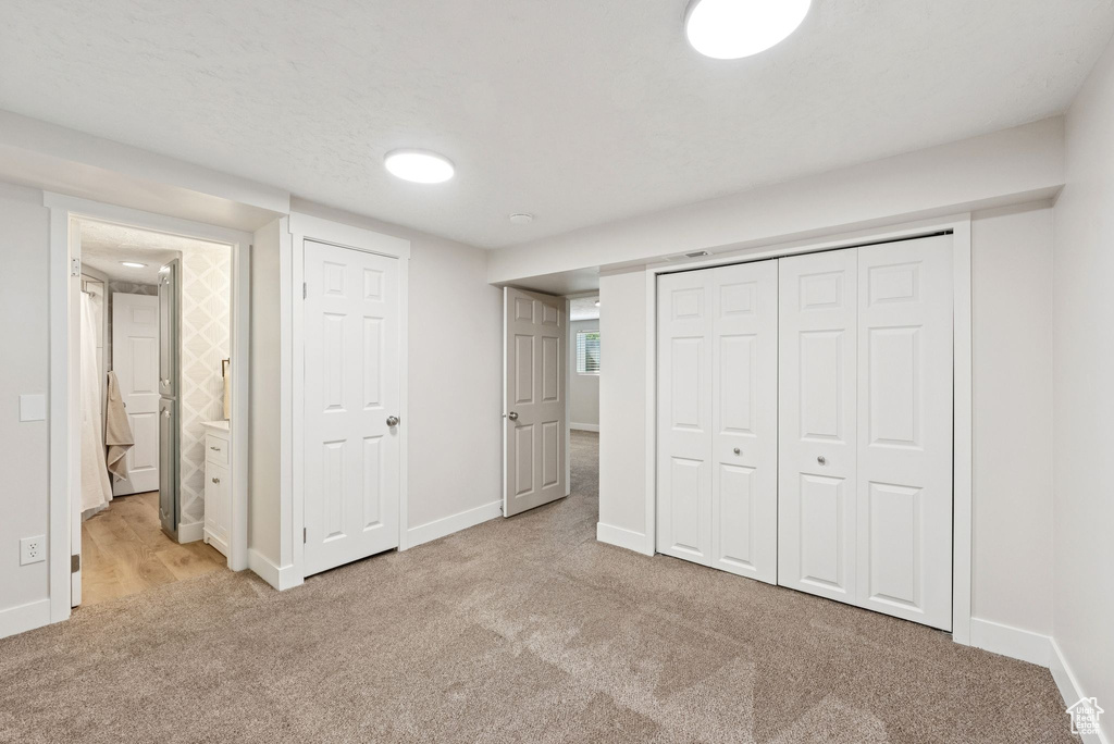 Unfurnished bedroom with carpet flooring and a closet