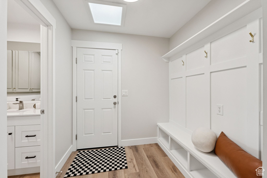 Mudroom featuring a sink and light wood-type flooring
