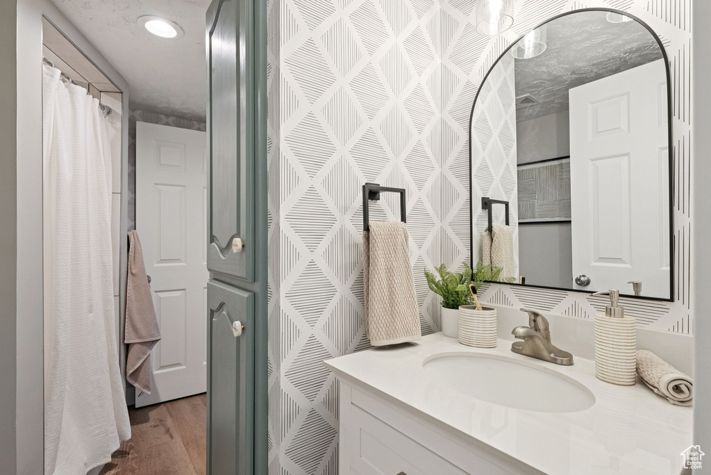 Full bathroom featuring vanity and wood finished floors