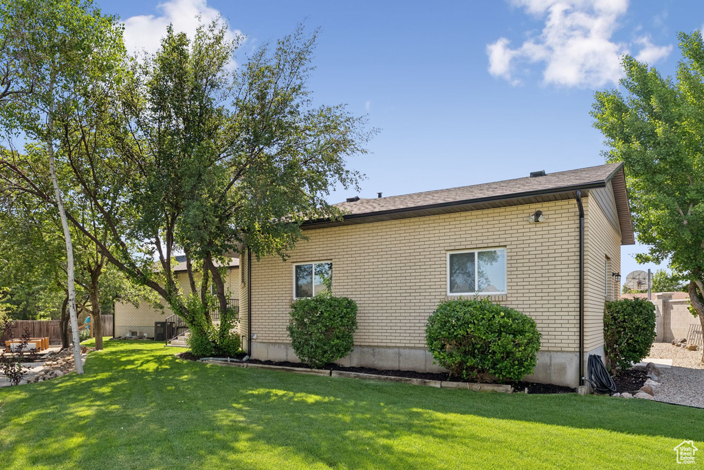View of property exterior featuring brick siding