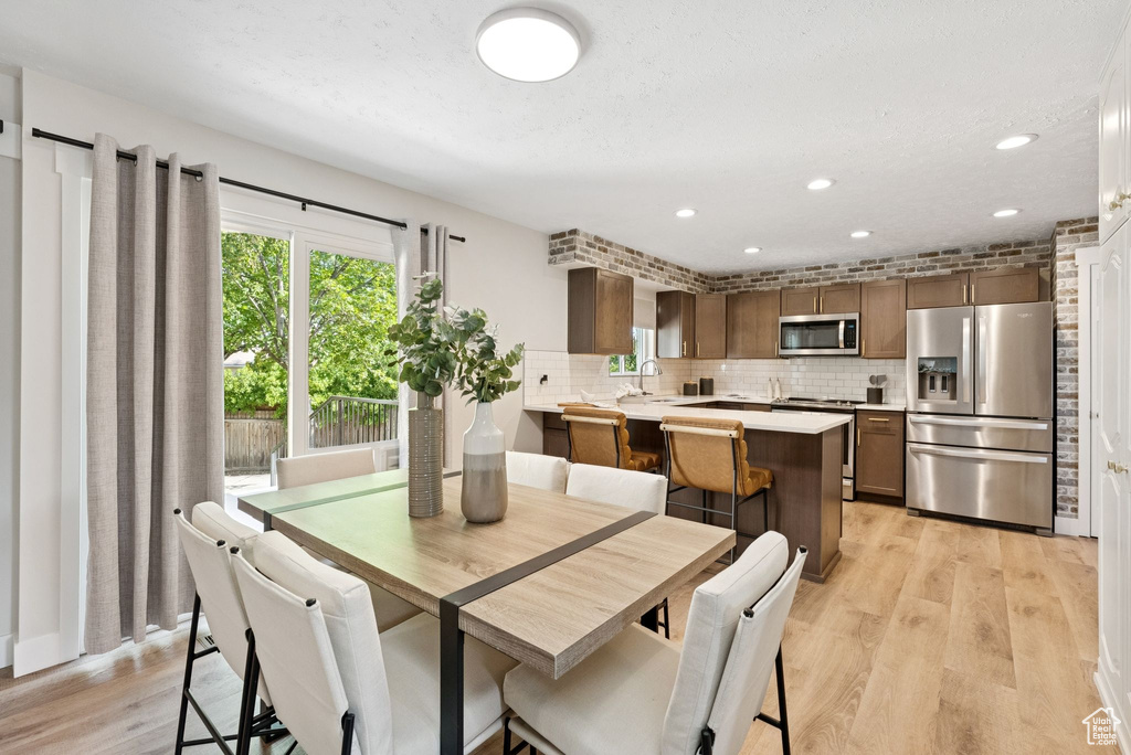 Dining room featuring light wood-style floors and recessed lighting
