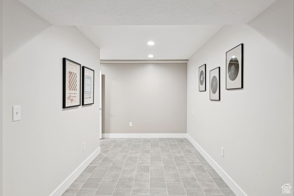 Basement featuring recessed lighting and baseboards
