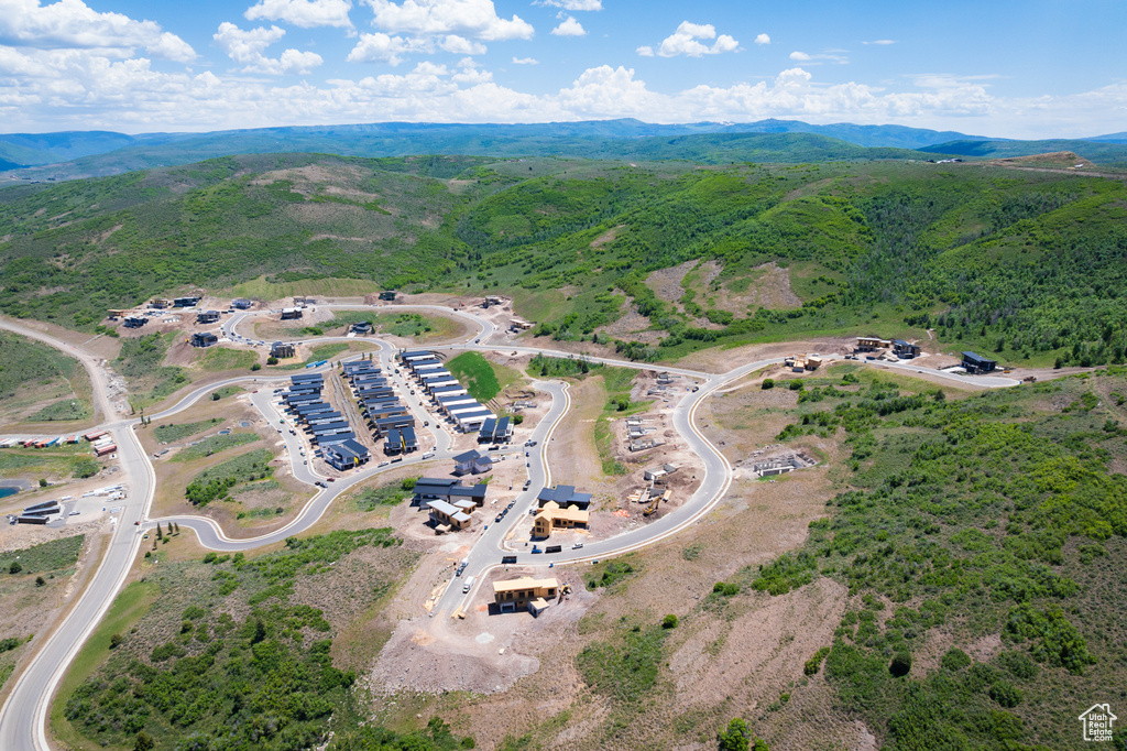 Aerial view of property and surrounding area with a mountainous background