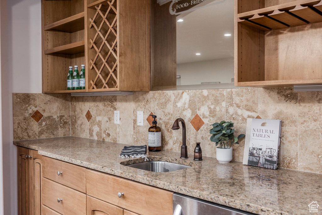 Kitchen featuring open shelves, light stone countertops, decorative backsplash, and recessed lighting
