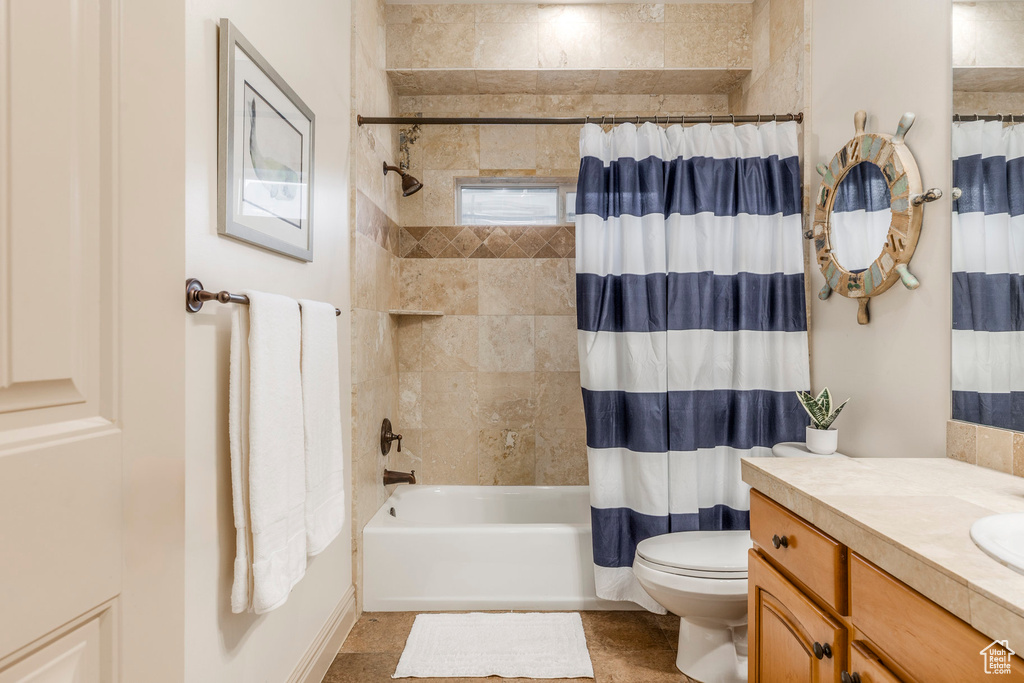 Bathroom featuring vanity and shower / bath combo with shower curtain