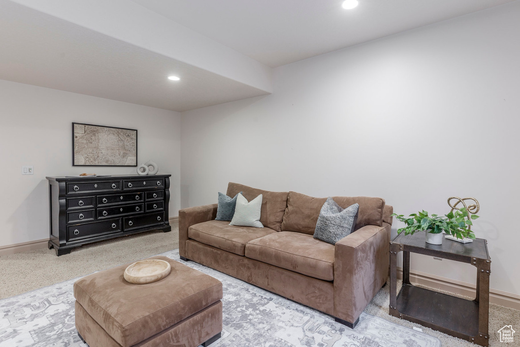 Living area with carpet floors and recessed lighting