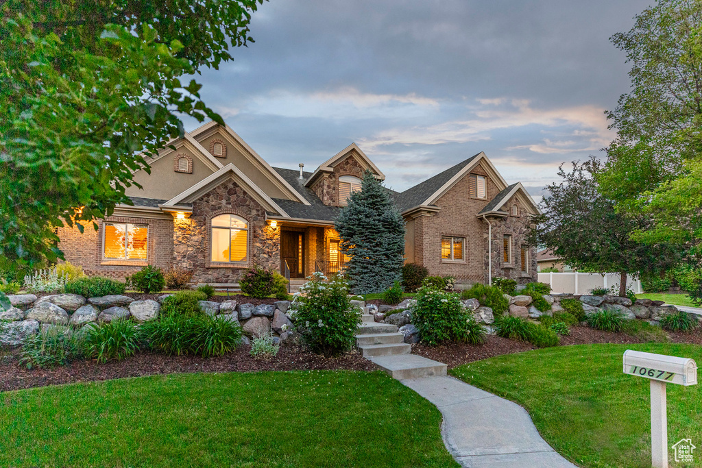 View of front facade featuring stone siding