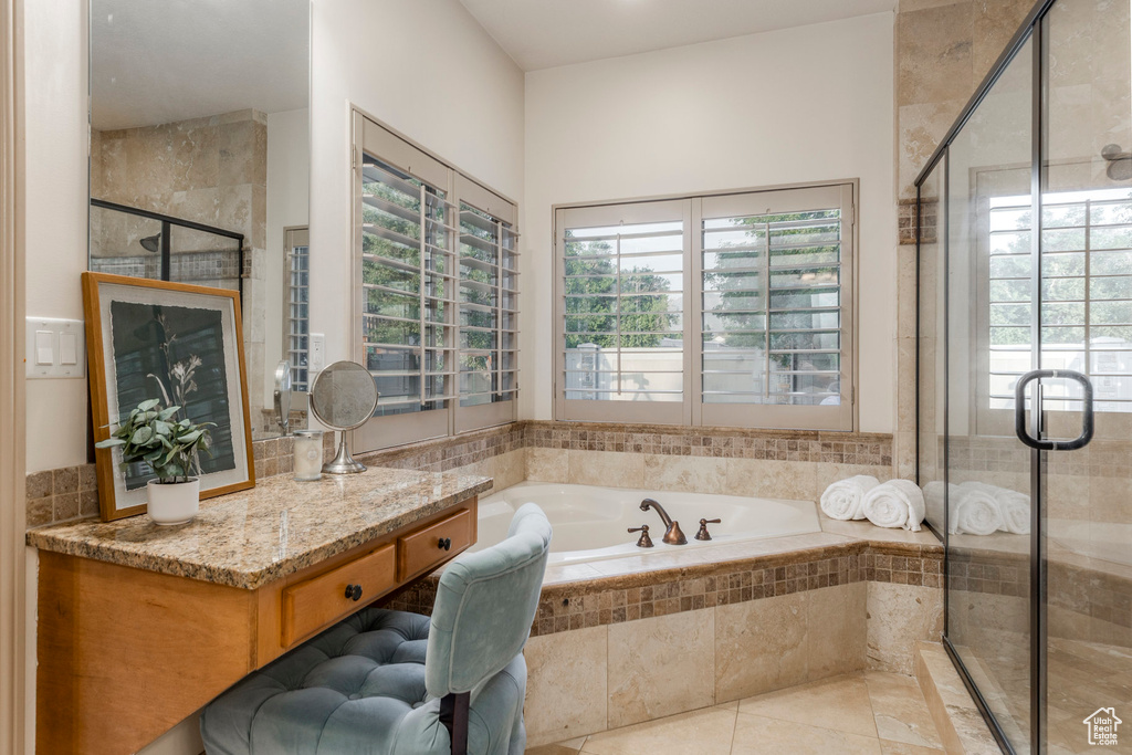 Full bathroom featuring a garden tub, a shower stall, and tile patterned flooring