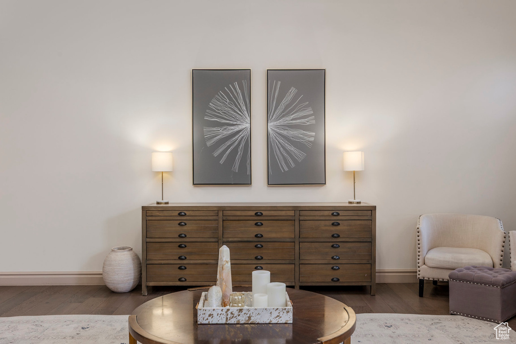 Living area with baseboards and wood finished floors