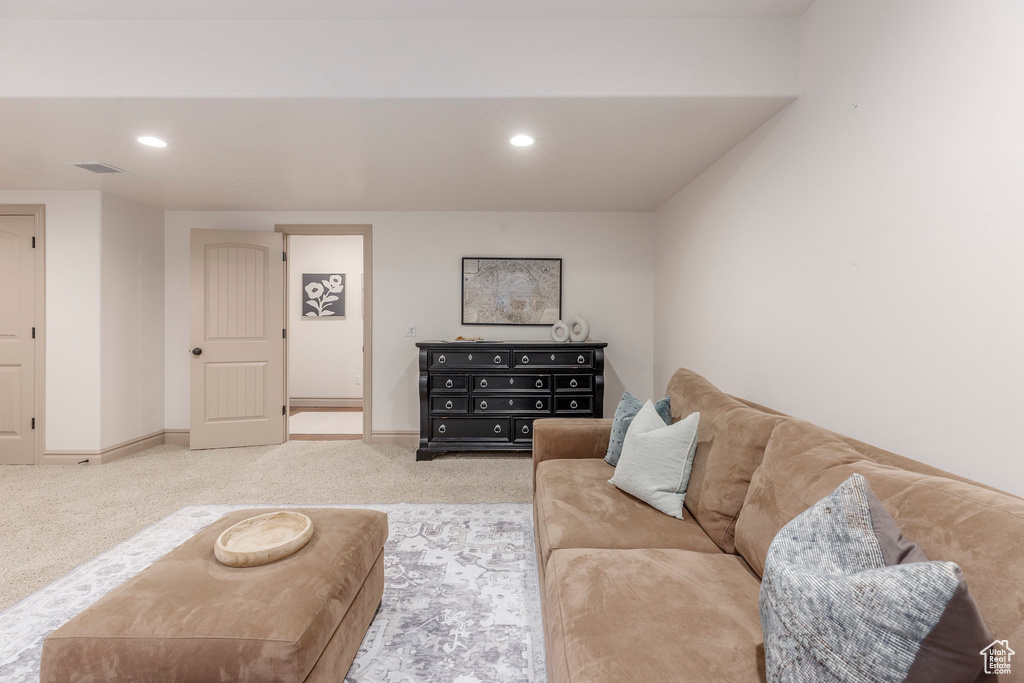 Living room featuring light colored carpet and recessed lighting