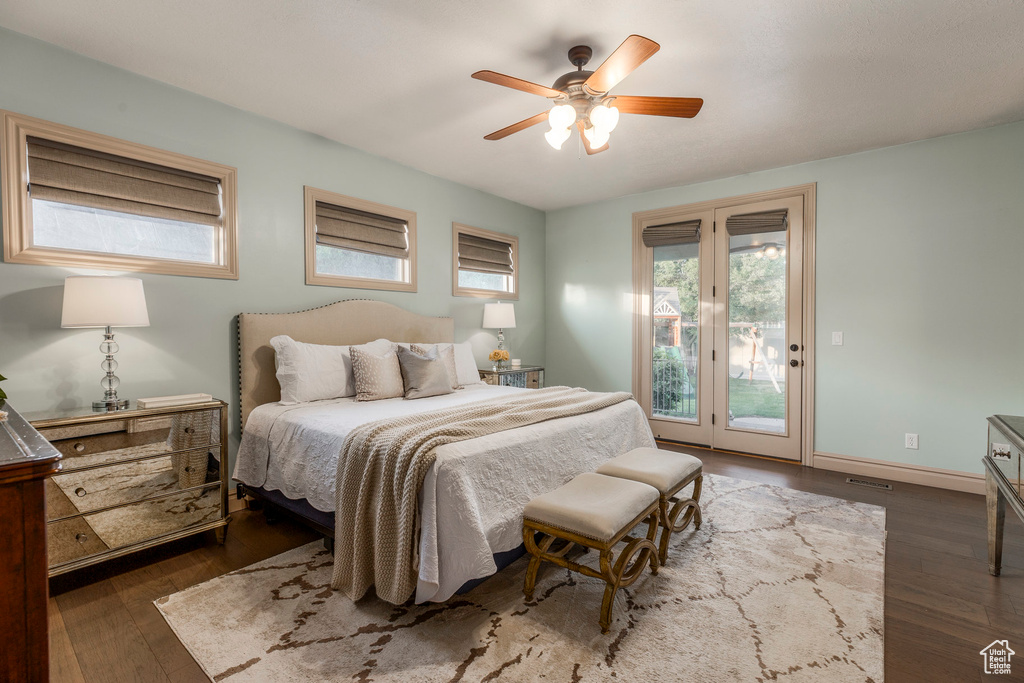 Bedroom featuring access to exterior, wood finished floors, and ceiling fan