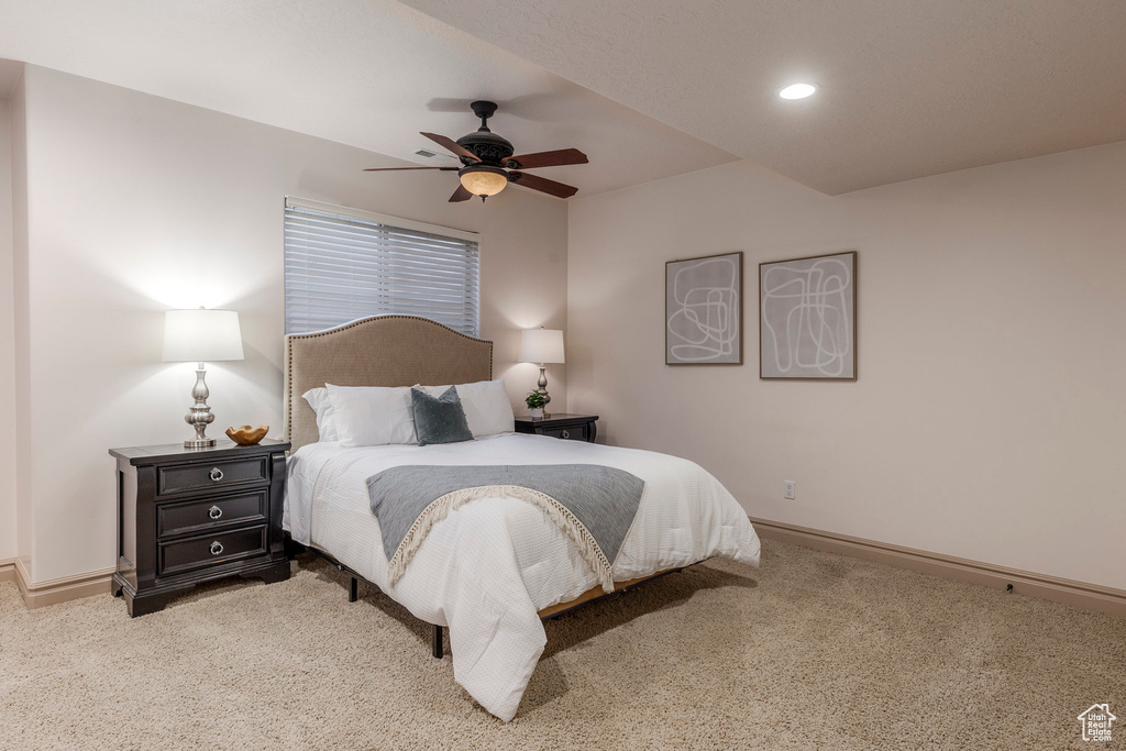 Bedroom with light colored carpet, recessed lighting, and ceiling fan