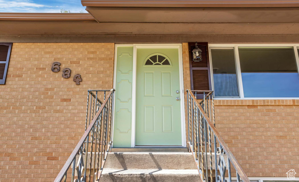 Doorway to property with brick siding