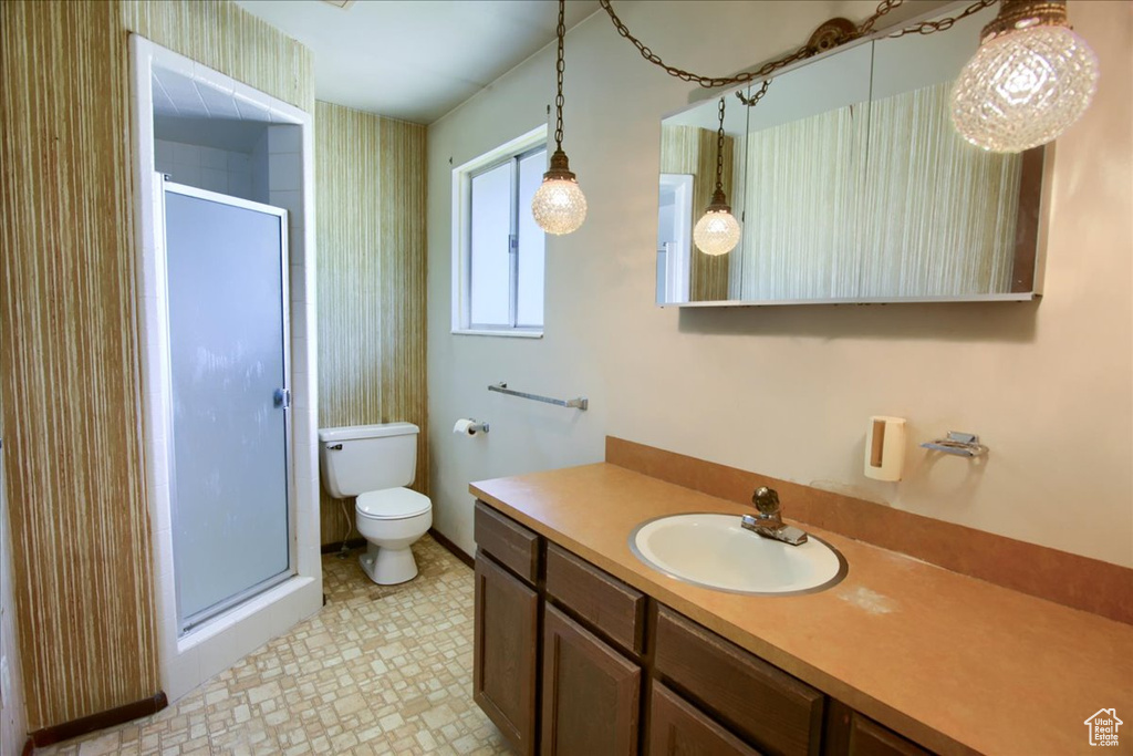 Full bath with a shower stall, vanity, and tile patterned floors