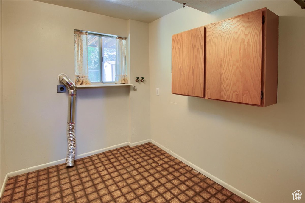 Unfurnished room with tile patterned floors and baseboards