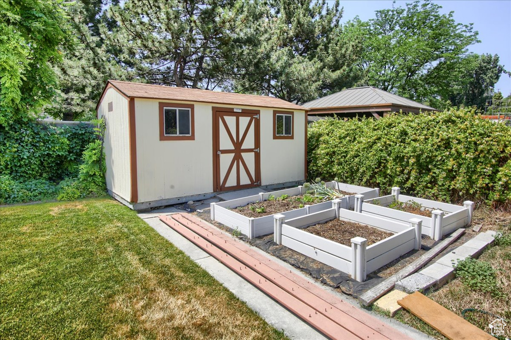 View of shed with a vegetable garden