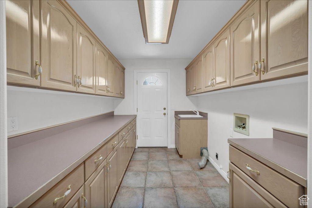Washroom featuring cabinet space and washer hookup