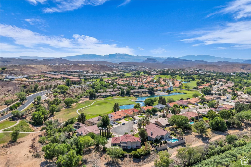 Aerial view of residential area featuring a water and mountain view and a golf course