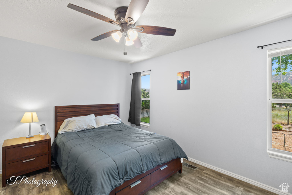 Bedroom featuring wood finished floors and a ceiling fan