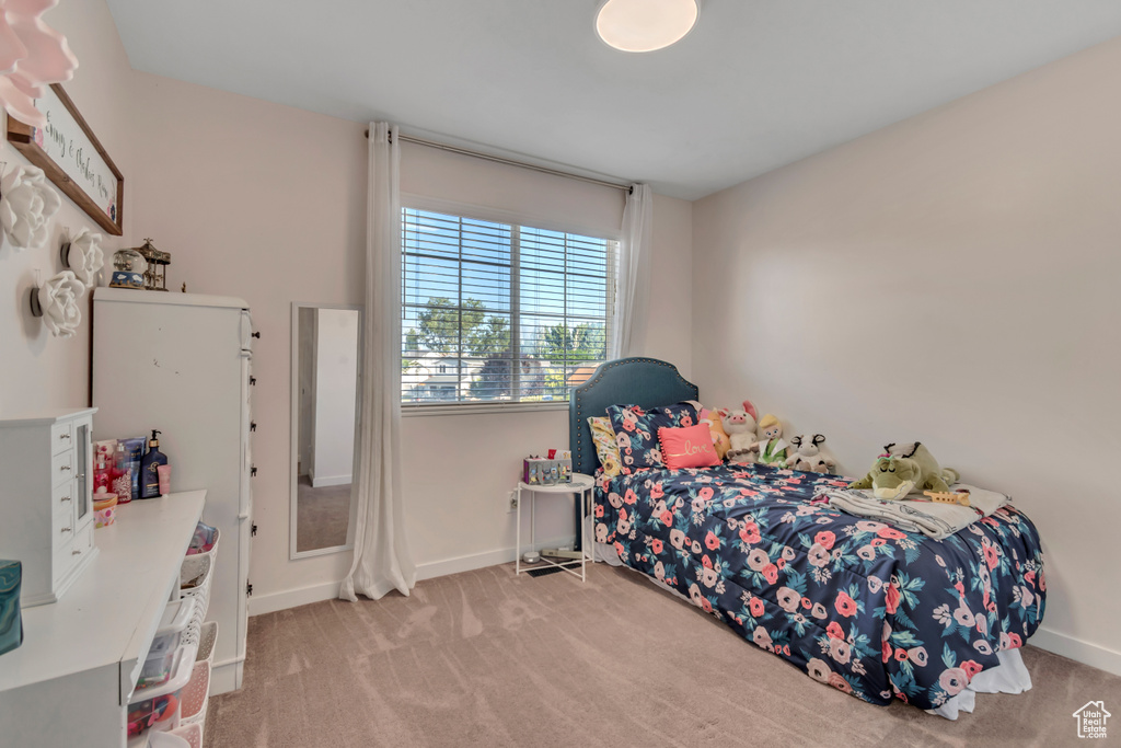 Carpeted bedroom featuring baseboards