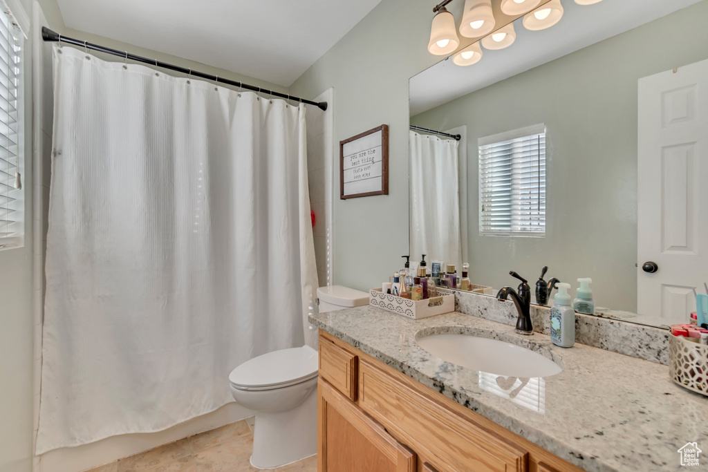 Full bath featuring vanity, a shower with curtain, and tile patterned floors