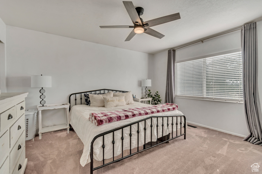 Bedroom featuring light carpet and ceiling fan