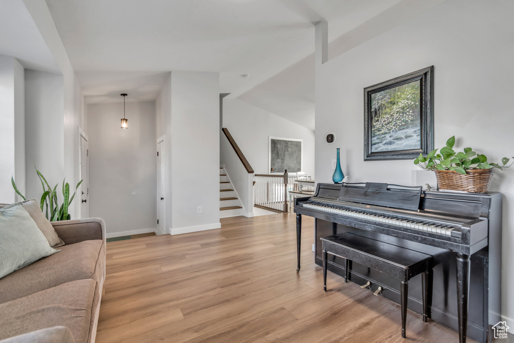 Living area featuring light wood-style flooring and stairs