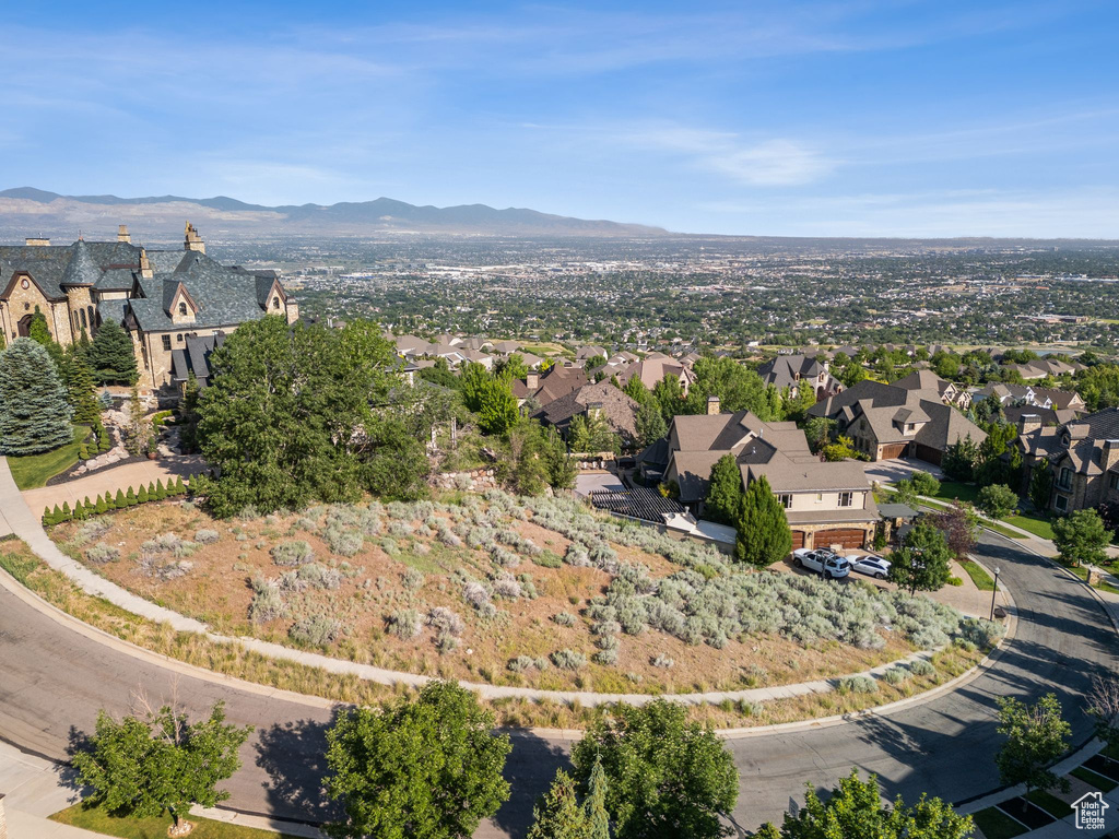 Aerial view of property's location featuring nearby suburban area and a mountainous background