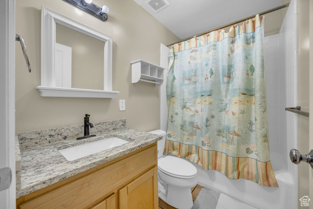 Bathroom featuring vanity and shower / bath combo