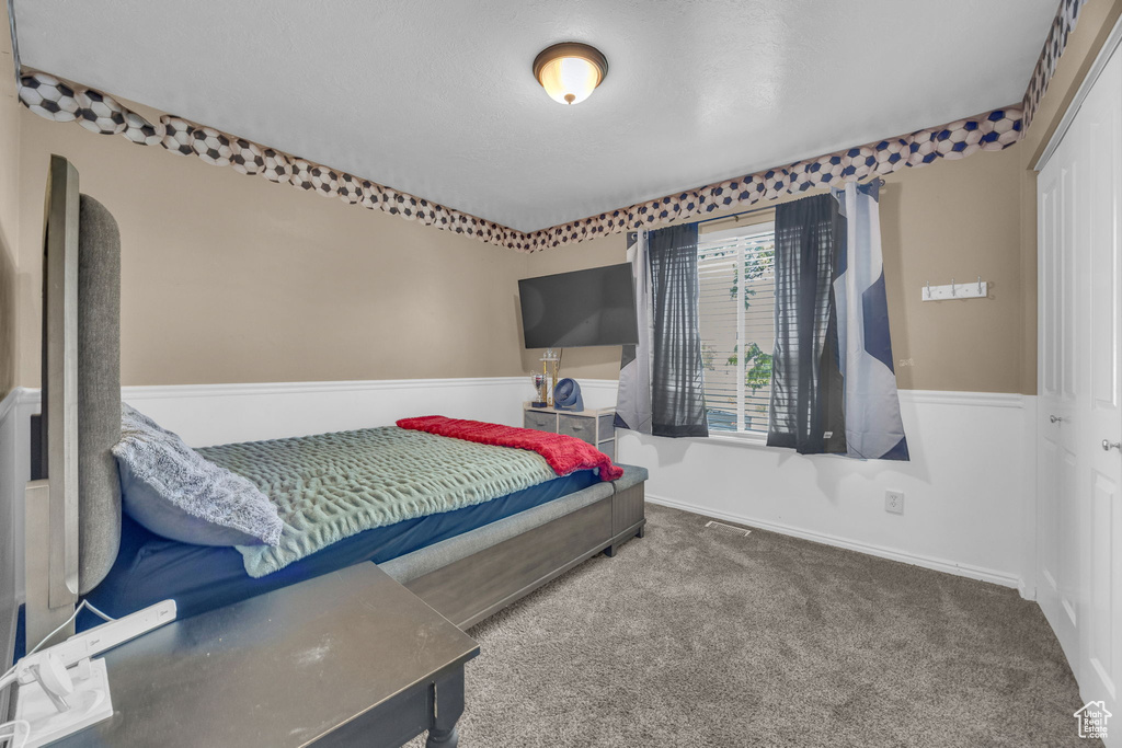 Carpeted bedroom featuring baseboards