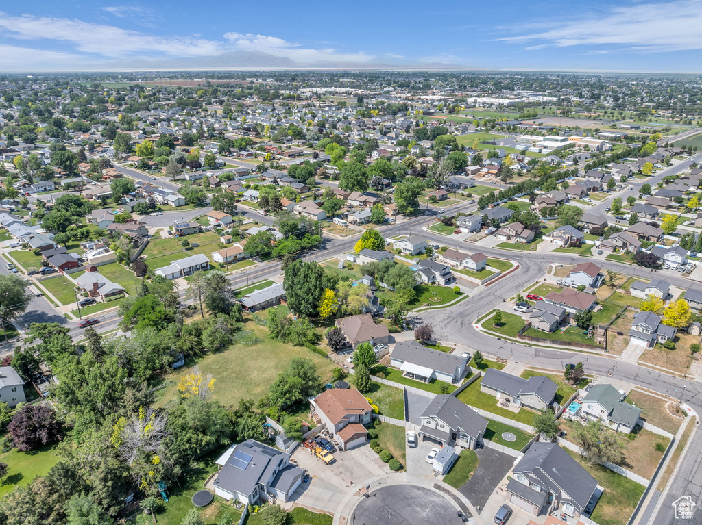 Aerial view of property and surrounding area featuring nearby suburban area