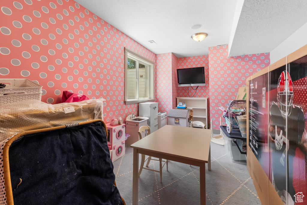 Carpeted bedroom featuring wallpapered walls