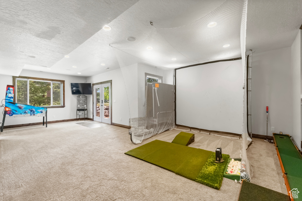 Home theater room featuring carpet flooring, recessed lighting, french doors, and a textured ceiling