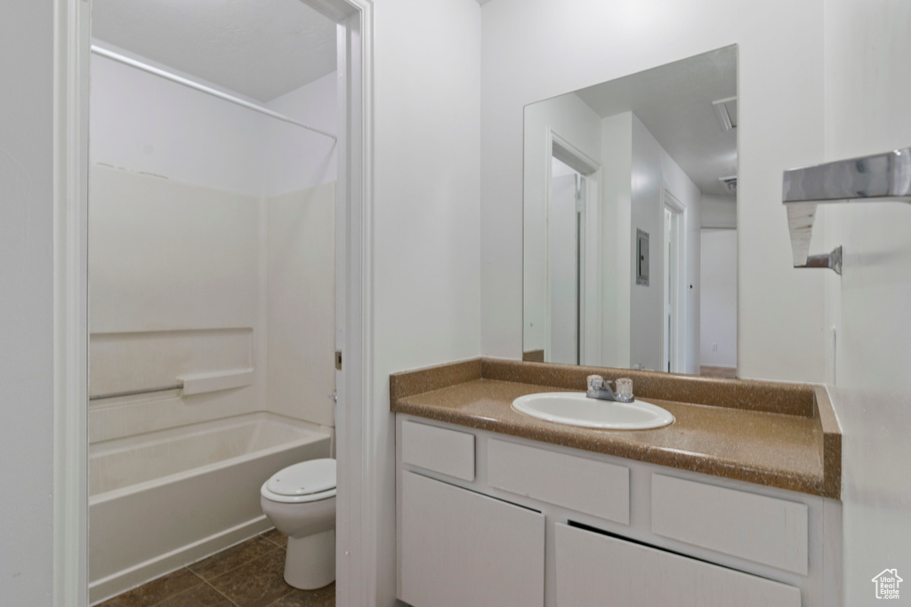 Full bathroom with vanity, washtub / shower combination, and tile patterned flooring