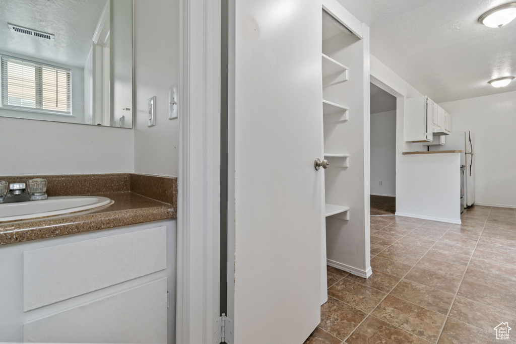 Bathroom featuring vanity and baseboards