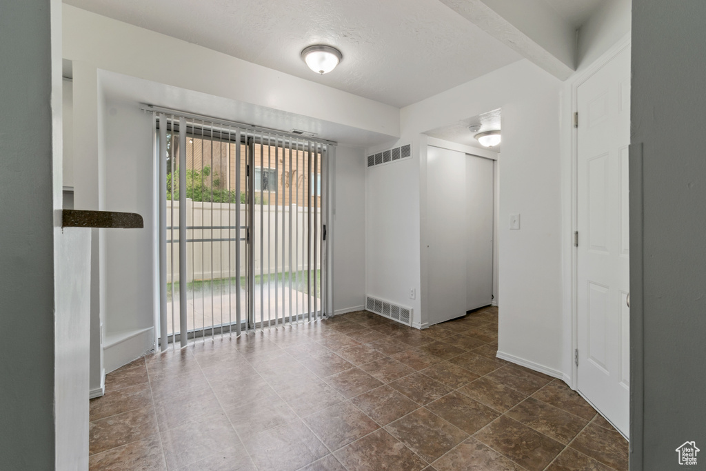 Empty room featuring baseboards