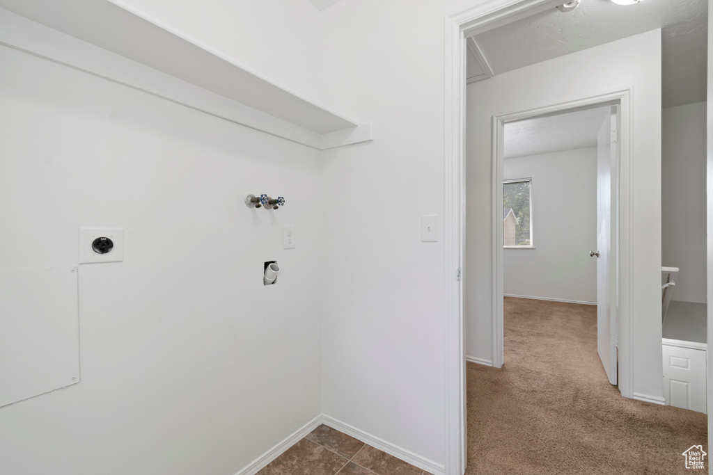 Laundry area with hookup for an electric dryer, washer hookup, and dark carpet