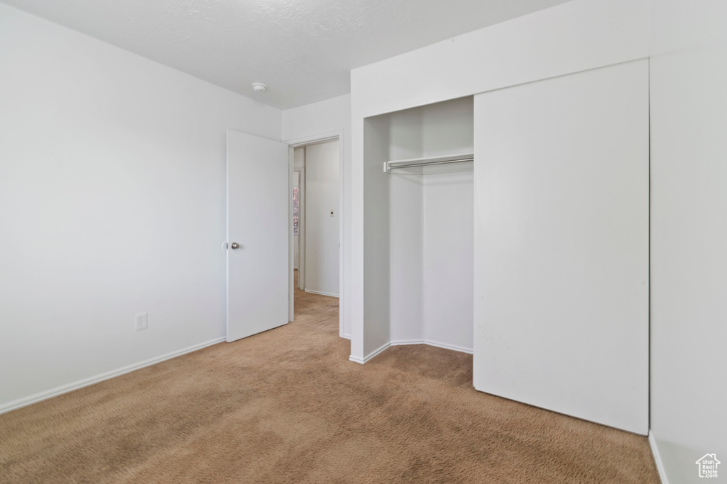 Unfurnished bedroom with carpet floors and a closet