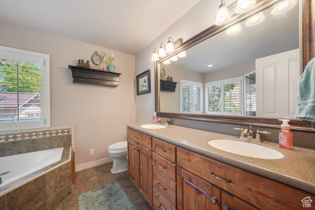Full bath featuring double vanity and a bath