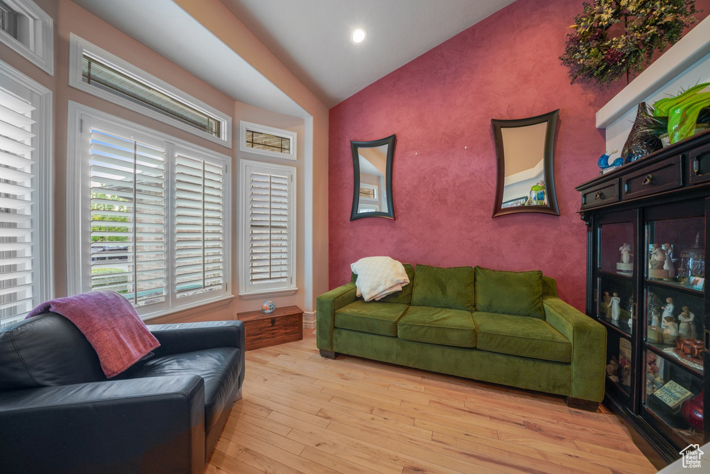 Living area with vaulted ceiling, hardwood / wood-style floors, and recessed lighting