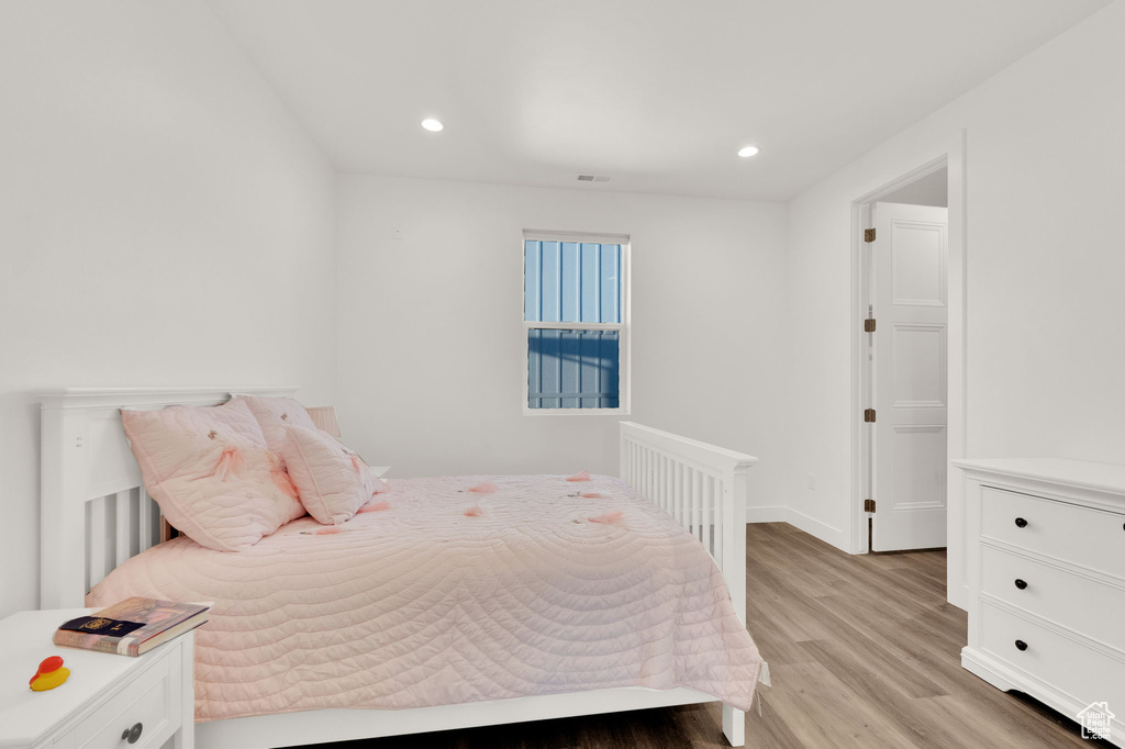 Bedroom with light wood-type flooring and recessed lighting