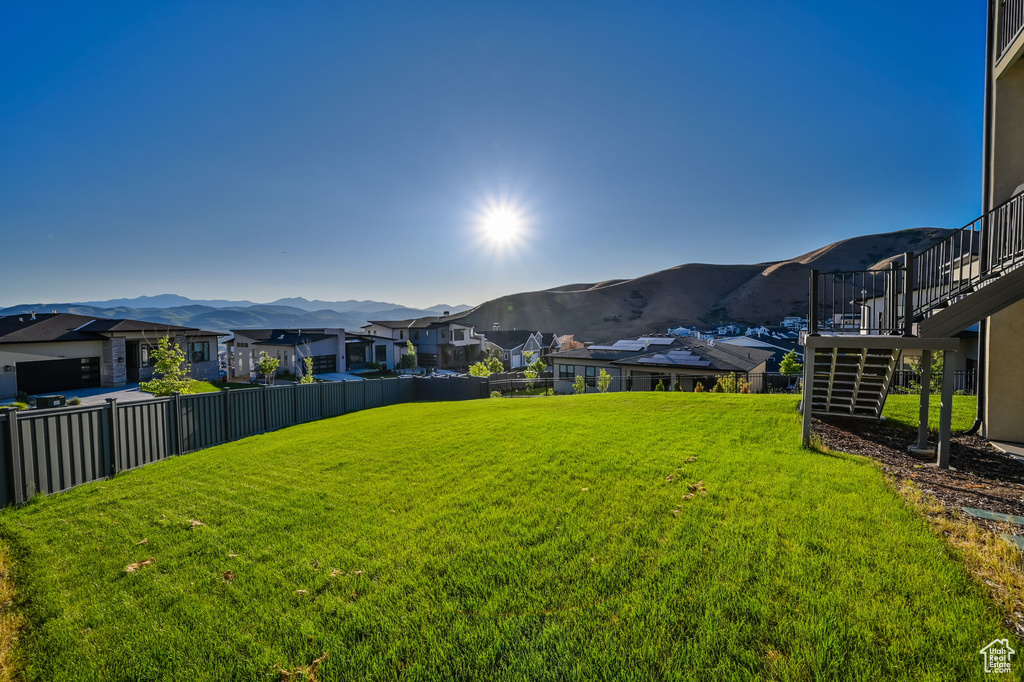 View of yard with a residential view, stairs, and a mountain view