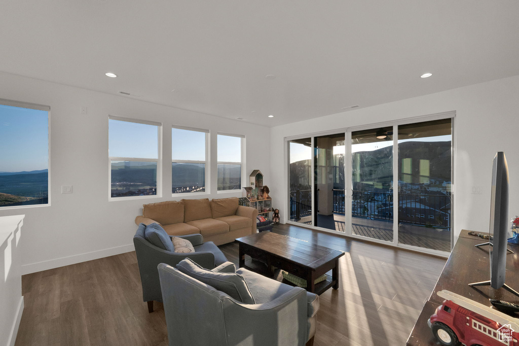 Living area featuring wood finished floors and recessed lighting