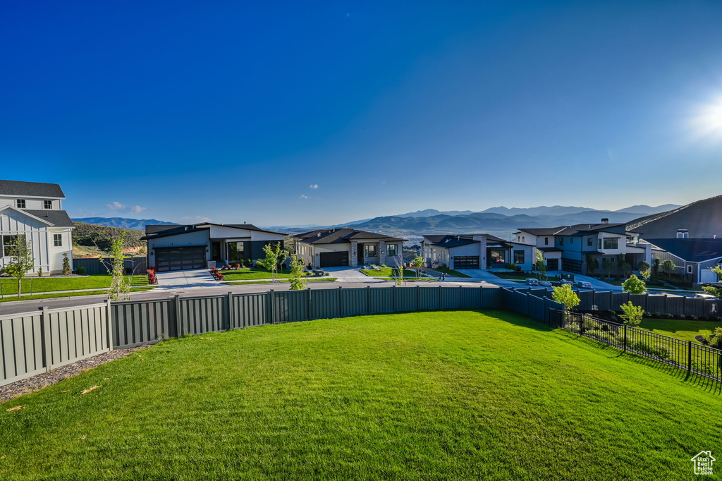 Fenced backyard with a residential view and a mountain view