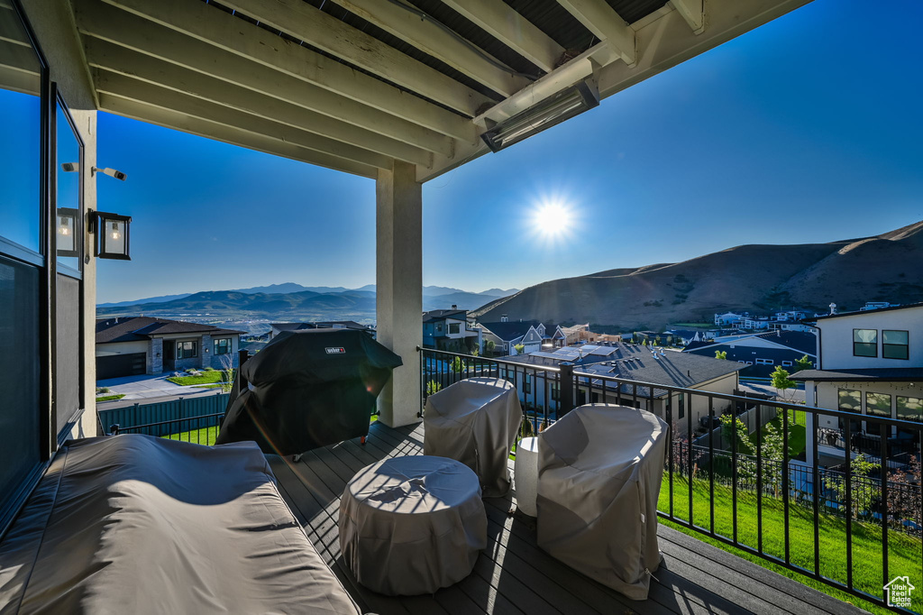Wooden terrace featuring a mountain view and a grill