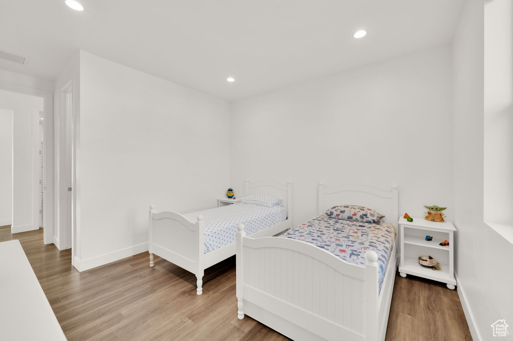 Bedroom featuring wood finished floors and recessed lighting