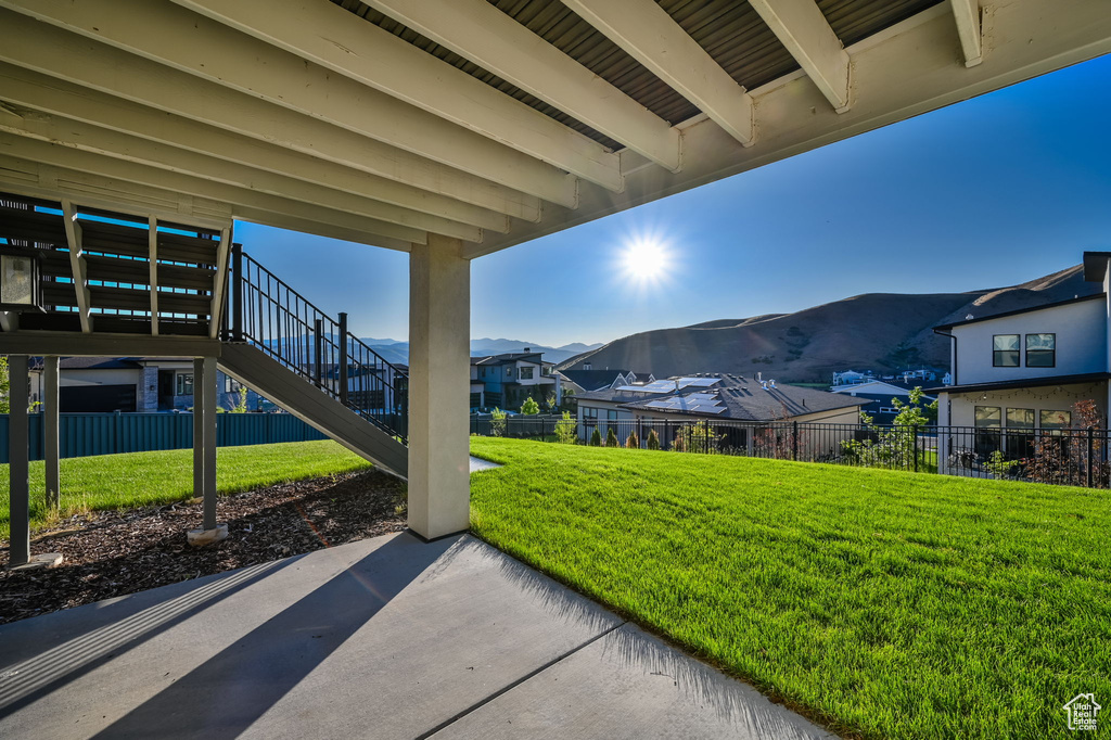 View of patio / terrace with a mountain view, stairway, and a residential view