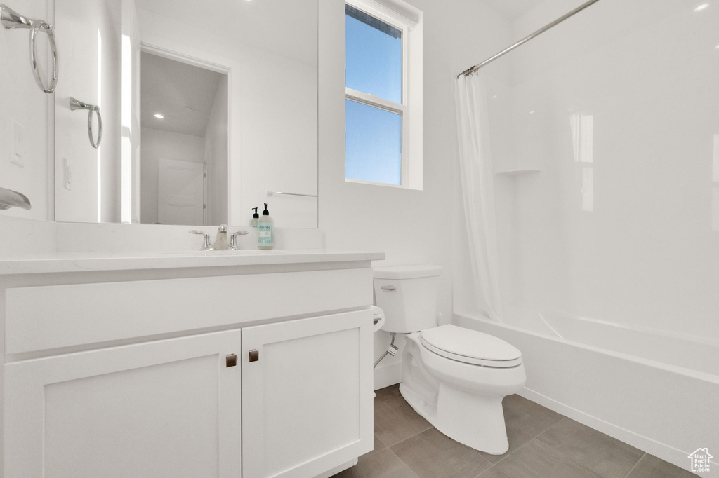Full bathroom featuring shower / bath combo, vanity, and tile patterned flooring